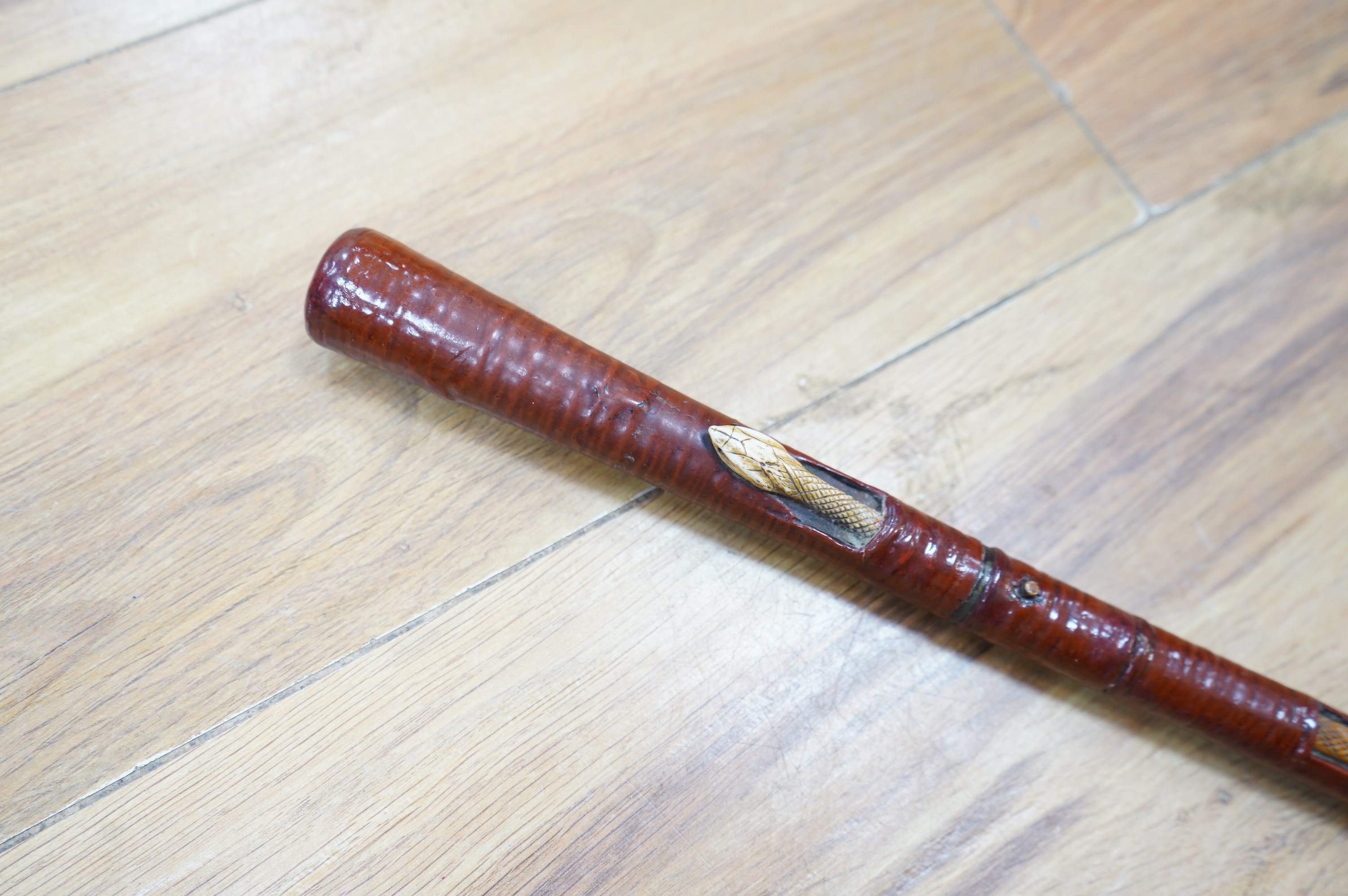 An Edwardian leather covered swordstick with ivory serpent to the shaft, blade 45cm, overall length 89cm. Condition fair to good, minor losses to leather work. CITES Submission reference, CKA5P6DV